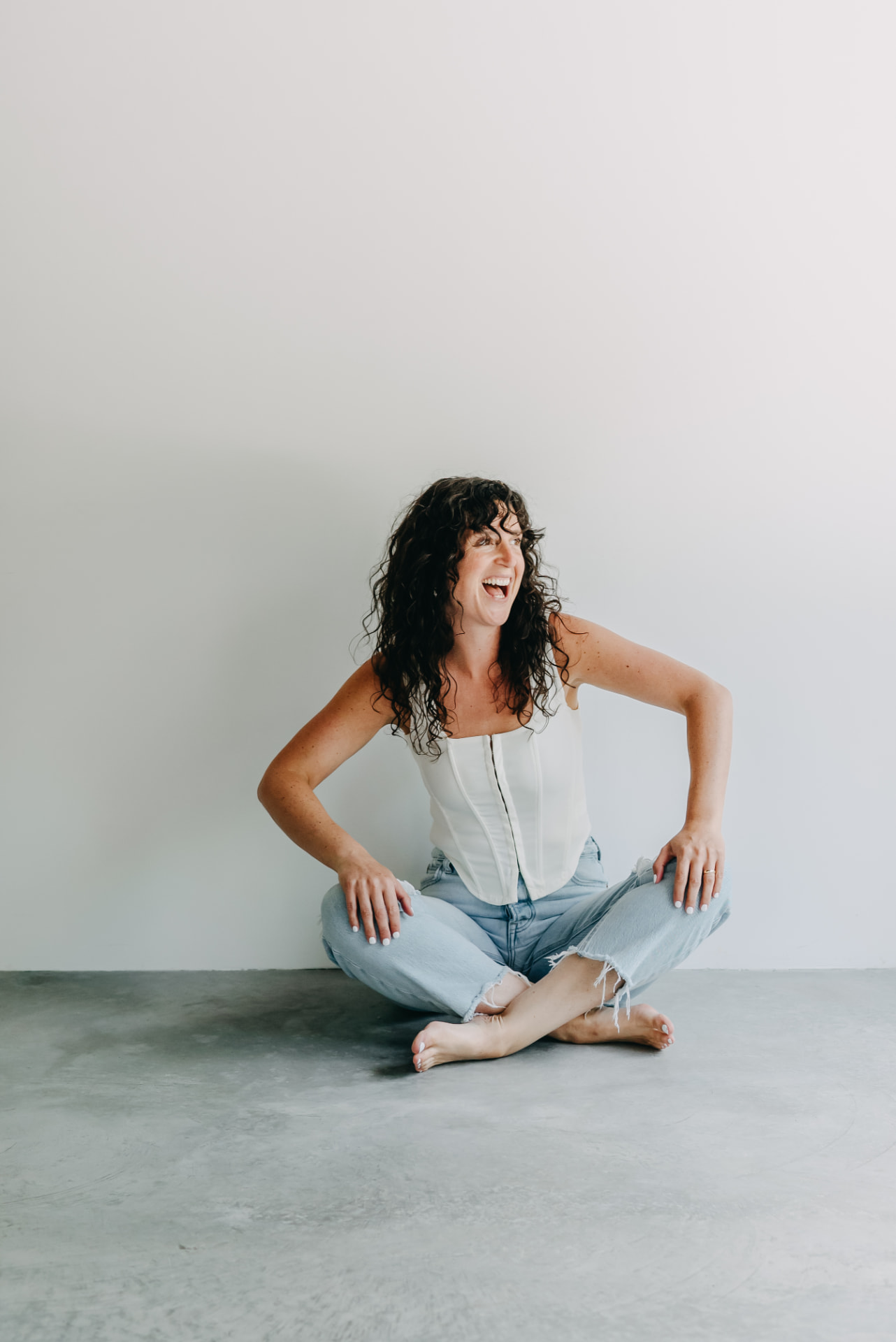 Shelby Foster seated and laughing naturally